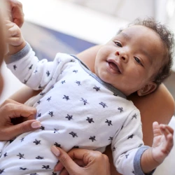 baby smiling at mother close up