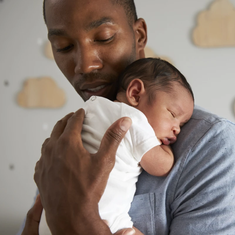 father holding newborn